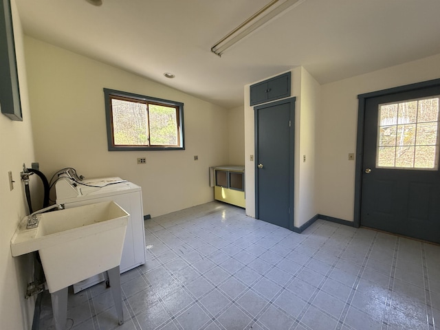 clothes washing area with laundry area, separate washer and dryer, tile patterned floors, and a healthy amount of sunlight
