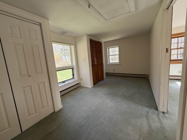 carpeted spare room with plenty of natural light, a baseboard radiator, and baseboard heating
