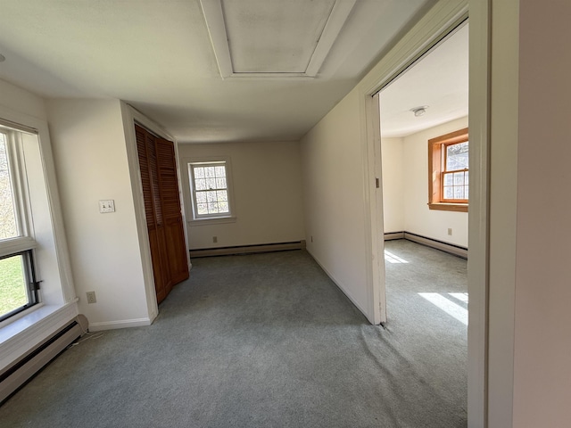 unfurnished room with a baseboard radiator, baseboard heating, and light colored carpet