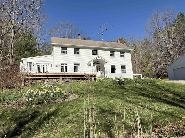 view of front of home with a chimney and a deck
