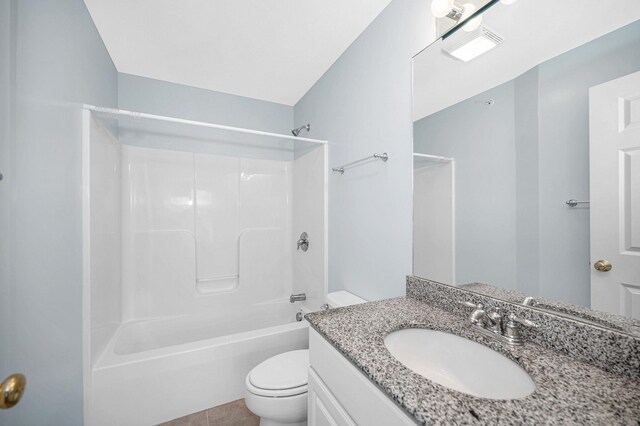 bathroom featuring toilet, tub / shower combination, tile patterned flooring, and vanity