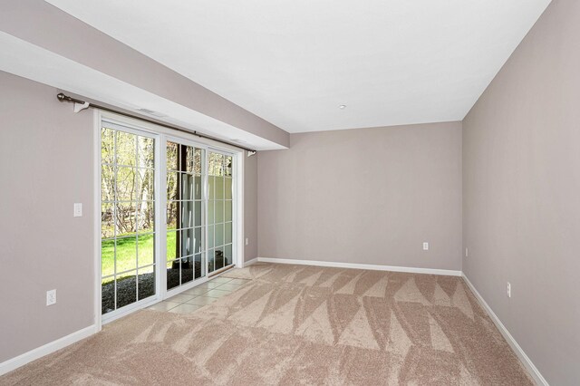 empty room featuring baseboards and carpet flooring