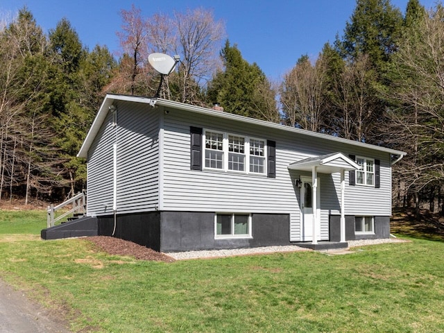 raised ranch with a front yard