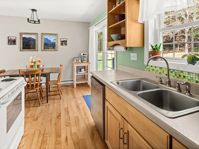 kitchen with stainless steel dishwasher, white gas range oven, a sink, and light countertops