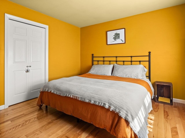 bedroom featuring baseboards and wood finished floors