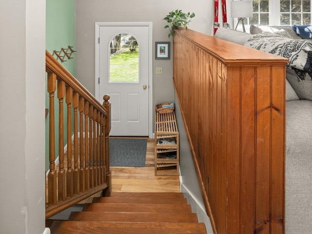 foyer entrance featuring stairway and wood finished floors