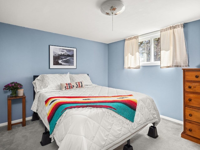 carpeted bedroom featuring baseboards