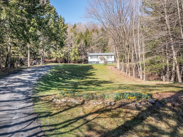exterior space featuring a wooded view