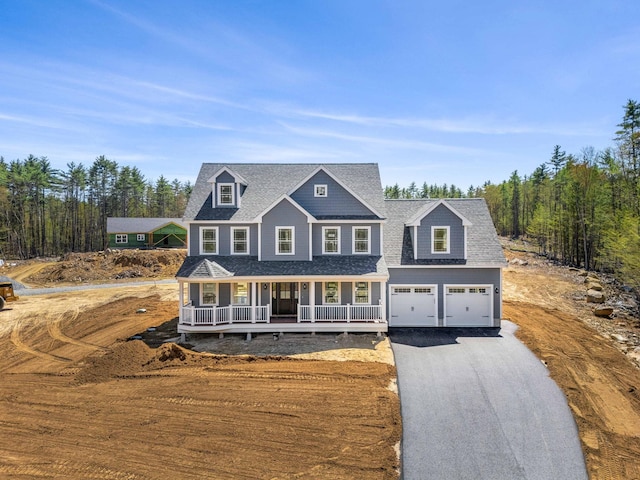 view of front of property featuring a porch, an attached garage, a shingled roof, and aphalt driveway