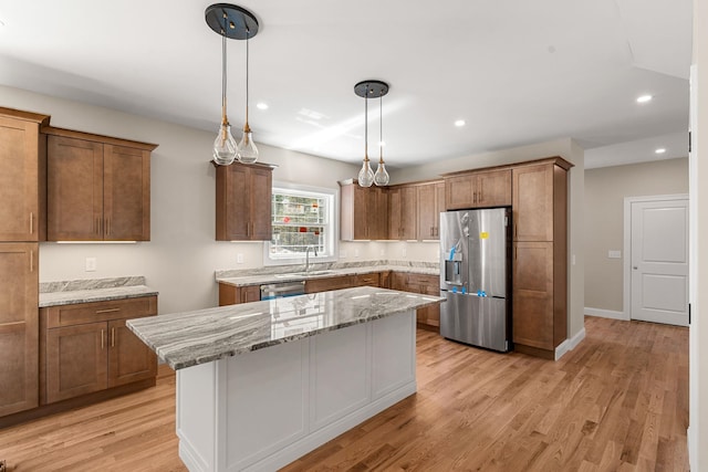 kitchen featuring a kitchen island, light stone countertops, stainless steel appliances, and recessed lighting