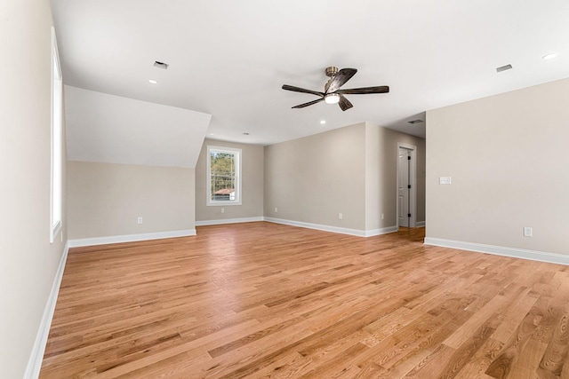 unfurnished living room featuring ceiling fan, visible vents, baseboards, and light wood finished floors