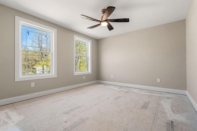 empty room featuring baseboards and ceiling fan