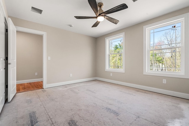 unfurnished room with baseboards, plenty of natural light, and ceiling fan