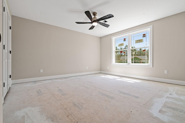 empty room featuring baseboards and ceiling fan