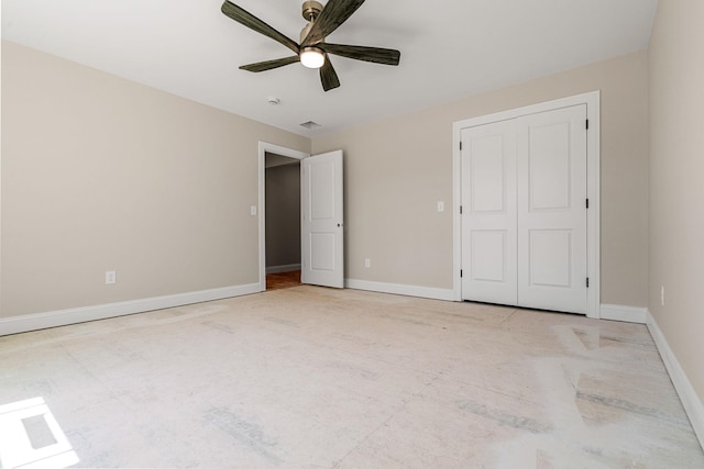 unfurnished bedroom with baseboards, ceiling fan, and a closet