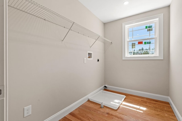 laundry room with hookup for an electric dryer, laundry area, baseboards, hookup for a washing machine, and light wood-style flooring