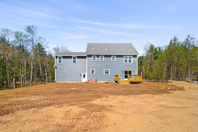 back of house featuring a deck