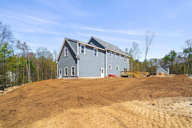 back of house with a deck