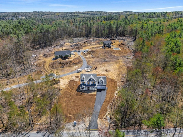 drone / aerial view featuring a forest view