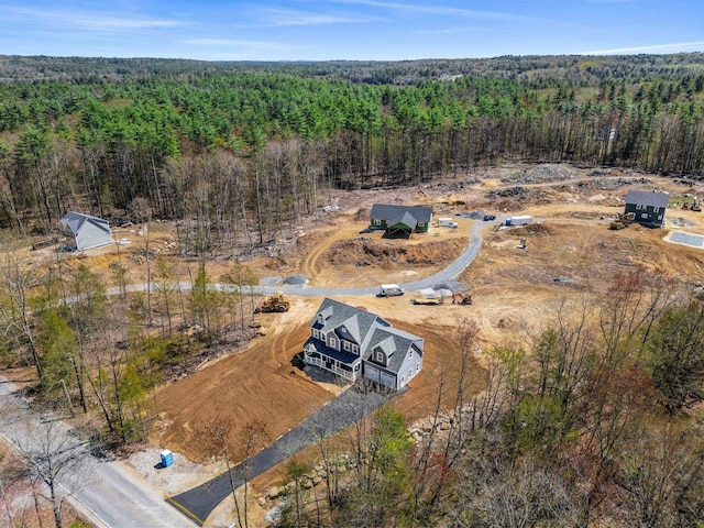birds eye view of property featuring a view of trees