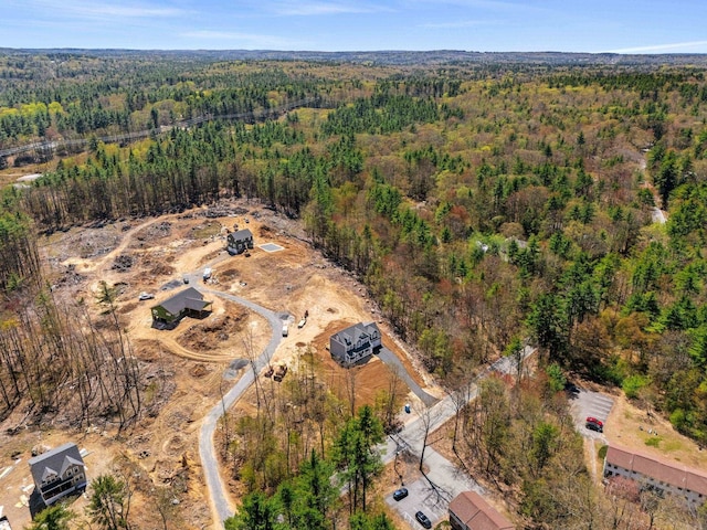 drone / aerial view with a wooded view