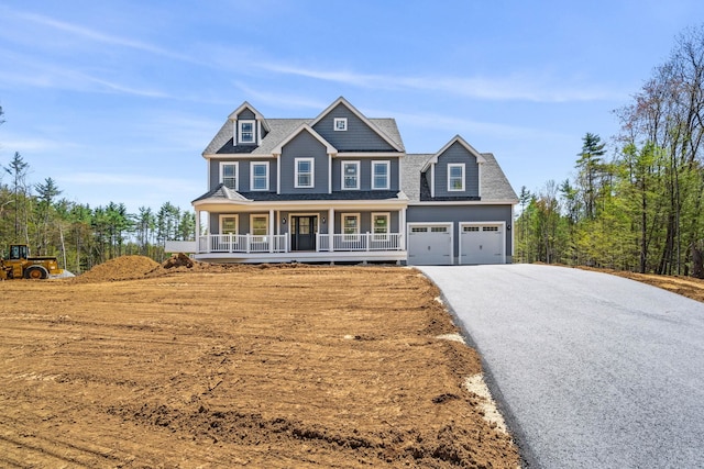 view of front of home with a porch and driveway