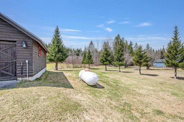 view of yard with fence and an outdoor structure