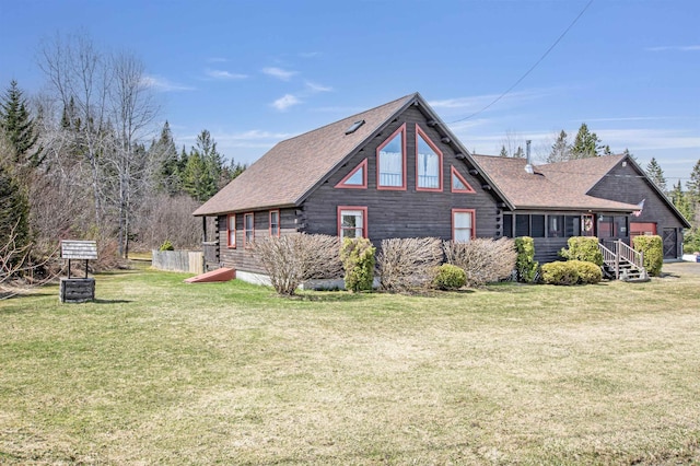 rear view of house with a lawn and a shingled roof