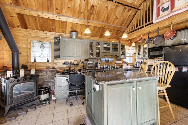 kitchen with wood ceiling, light tile patterned floors, and black appliances