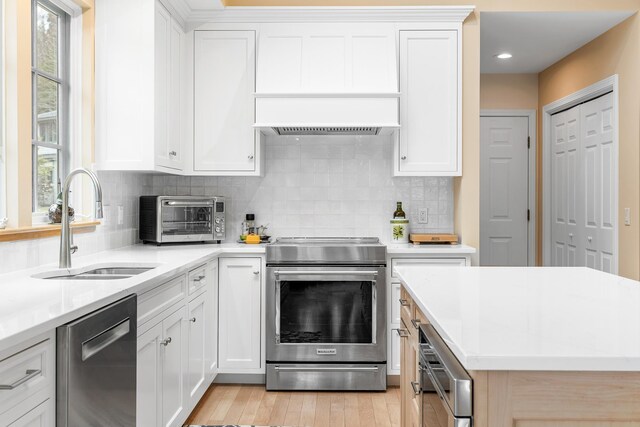 kitchen with light countertops, a sink, a toaster, and stainless steel appliances