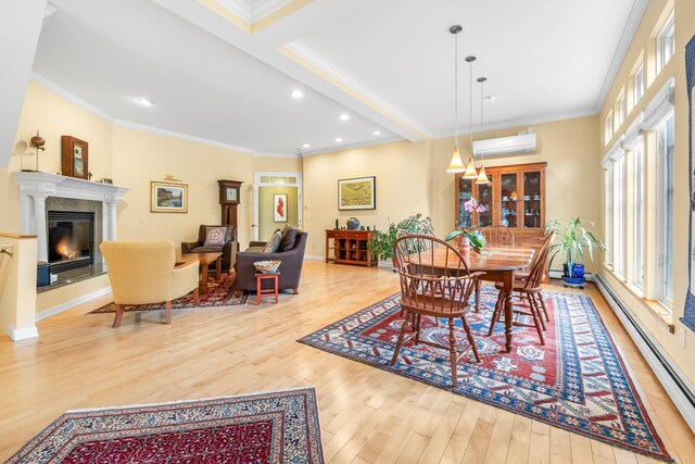 dining room with an AC wall unit, a baseboard radiator, crown molding, and wood finished floors