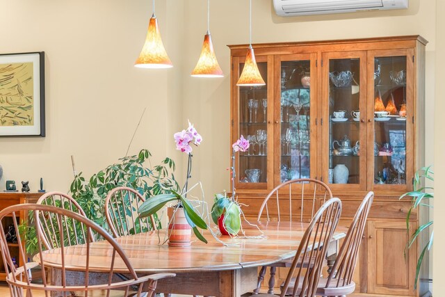dining area with a wall mounted air conditioner