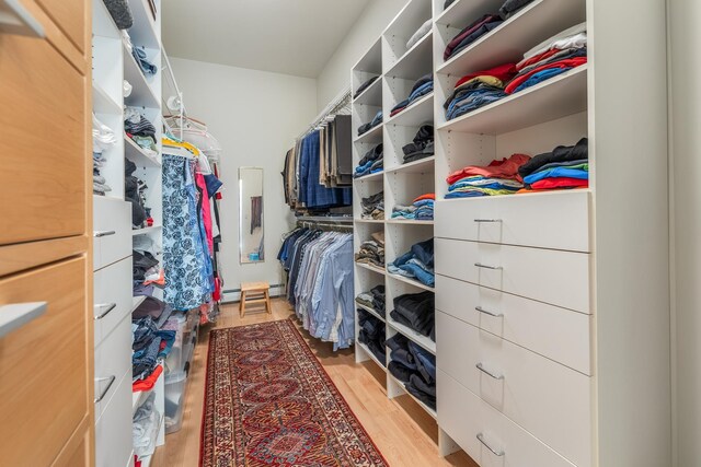 spacious closet with baseboard heating and light wood-style flooring