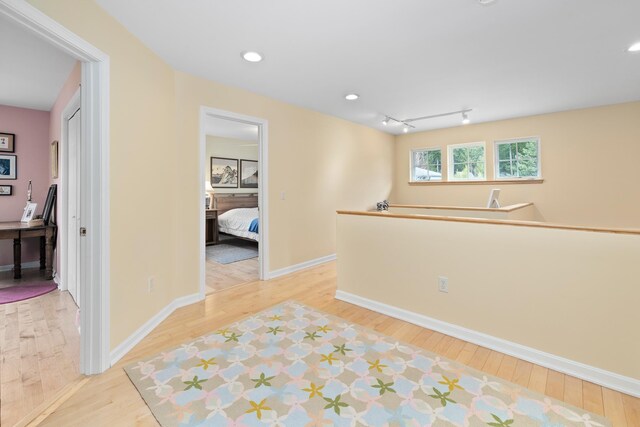interior space featuring light wood-style floors, recessed lighting, and baseboards