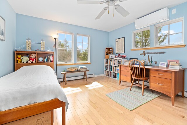 bedroom featuring ceiling fan, a baseboard radiator, baseboards, a wall unit AC, and light wood-type flooring