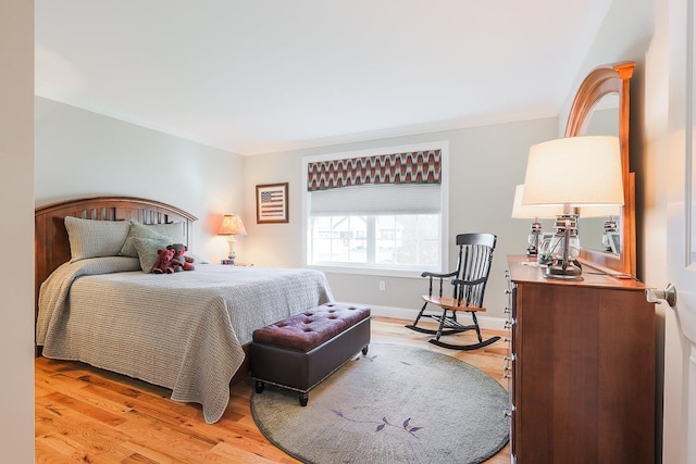 bedroom with baseboards and light wood finished floors