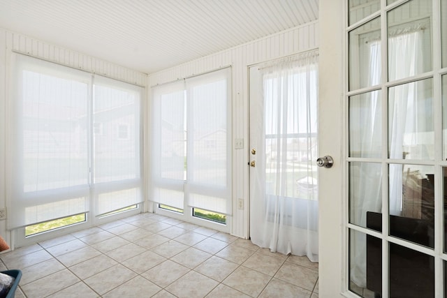 unfurnished sunroom featuring tile patterned flooring