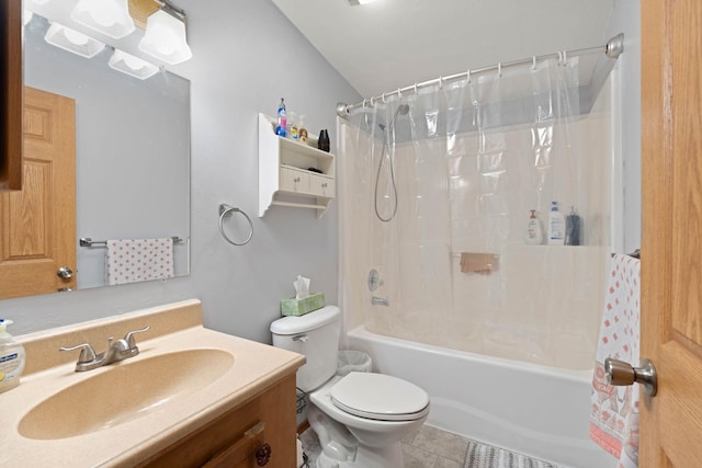 full bathroom featuring shower / bath combination with curtain, vaulted ceiling, vanity, tile patterned floors, and toilet
