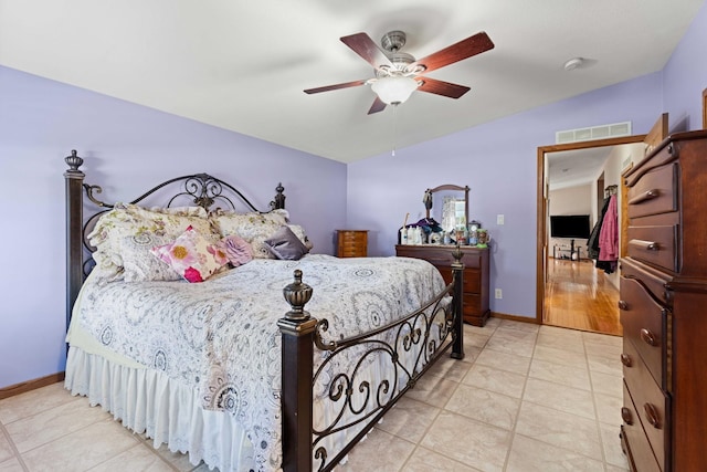 bedroom with light tile patterned flooring, a ceiling fan, baseboards, lofted ceiling, and visible vents