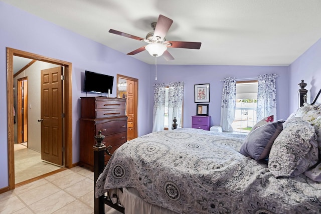 bedroom featuring a ceiling fan, vaulted ceiling, and multiple windows