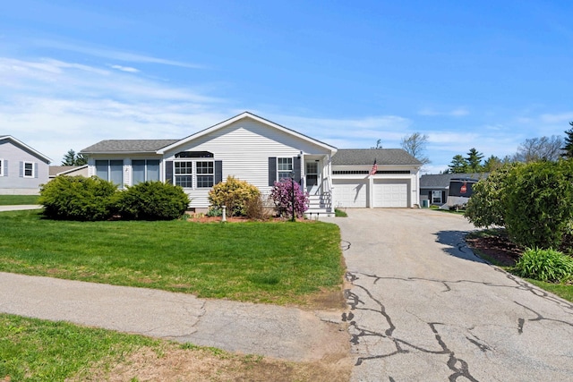 ranch-style house with a garage, a front lawn, and aphalt driveway
