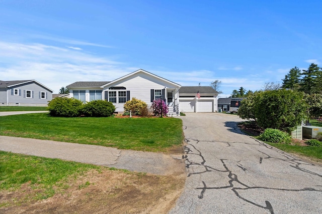ranch-style house with driveway and a front yard