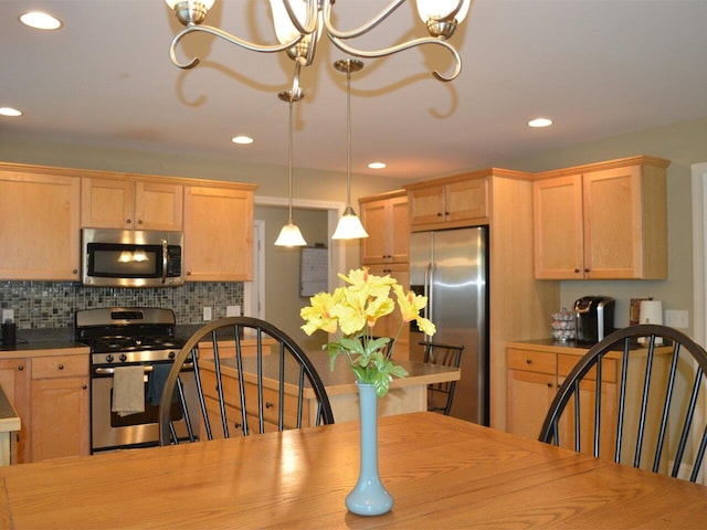 kitchen with light brown cabinetry, recessed lighting, appliances with stainless steel finishes, and a chandelier