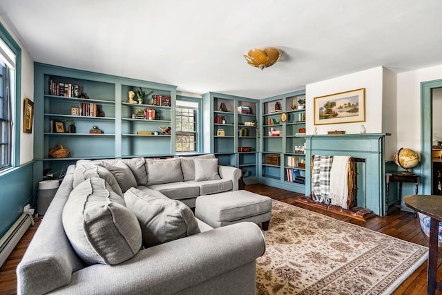living area with baseboard heating, a fireplace, dark wood finished floors, and a wealth of natural light