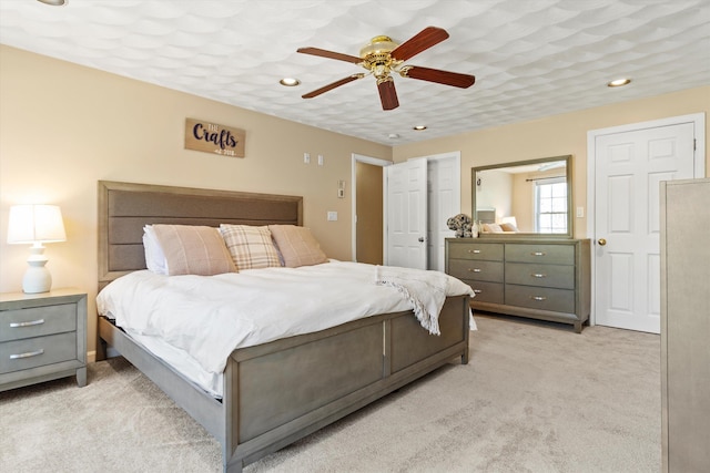 bedroom featuring recessed lighting, a ceiling fan, and light carpet