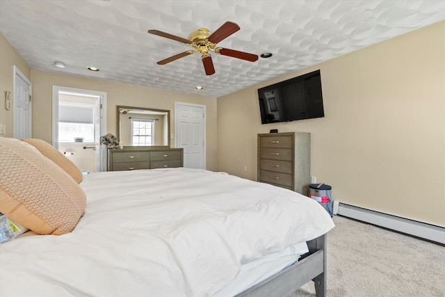 carpeted bedroom featuring recessed lighting, a ceiling fan, and a baseboard radiator