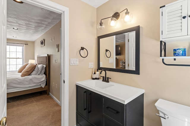 bathroom featuring toilet, baseboards, ensuite bath, and vanity