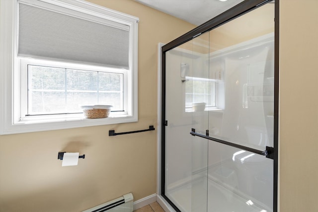 bathroom with a baseboard radiator, a healthy amount of sunlight, and a stall shower