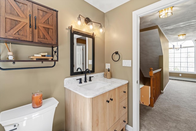 half bath with vanity, a baseboard radiator, baseboards, and toilet