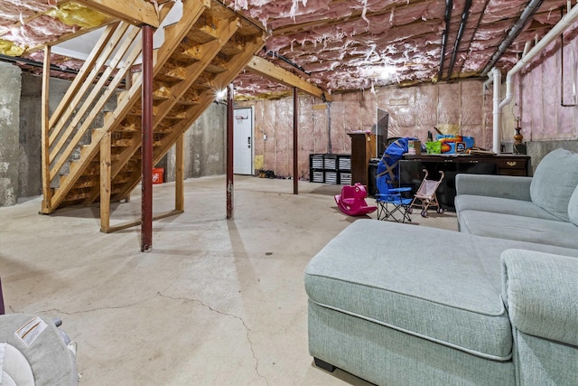 unfinished basement featuring stairs